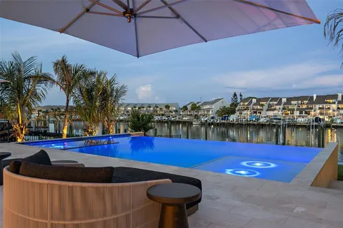 a view of swimming pool with outdoor seating and city view