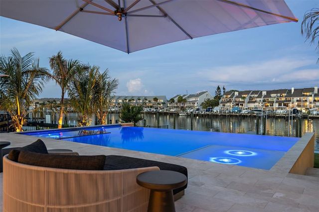 a view of swimming pool with outdoor seating and city view