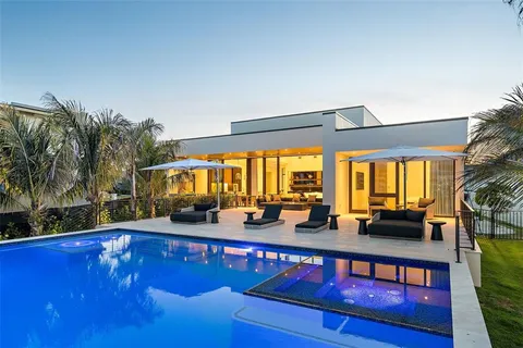 a view of swimming pool with a table and chairs in the patio