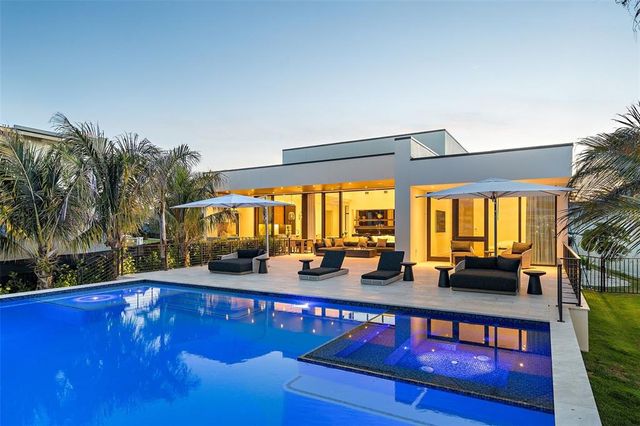 a view of swimming pool with a table and chairs in the patio