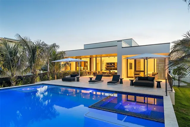 a view of swimming pool with a table and chairs in the patio