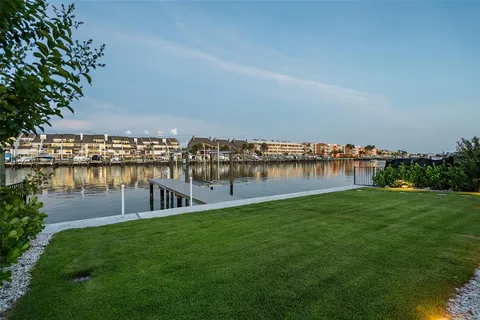 a view of a house with swimming pool and sitting area