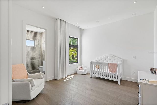 a bathroom with a granite countertop toilet sink and mirror