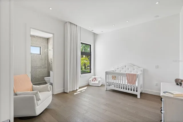 a bathroom with a granite countertop toilet sink and mirror