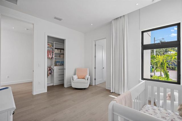 a large white bed in a white room