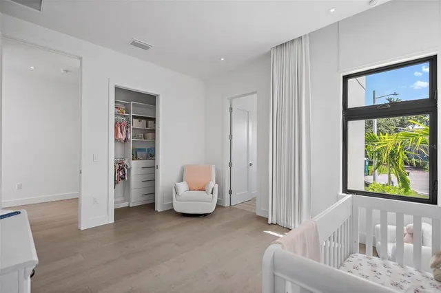 a large white bed in a white room