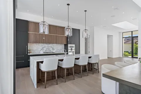 a large kitchen with a table and chairs