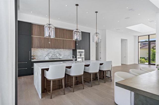 a large kitchen with a table and chairs