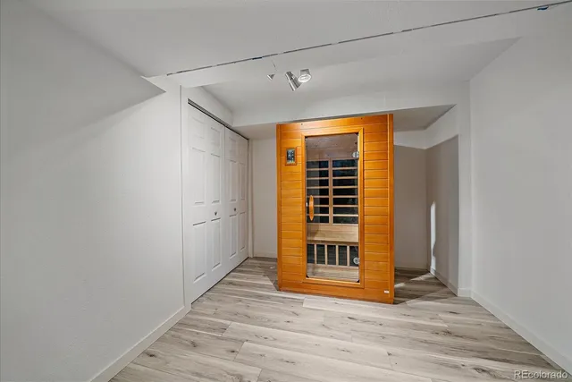 a view of a room with wooden floor and fence
