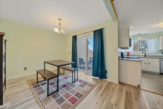 a view of a dining room with furniture and a chandelier