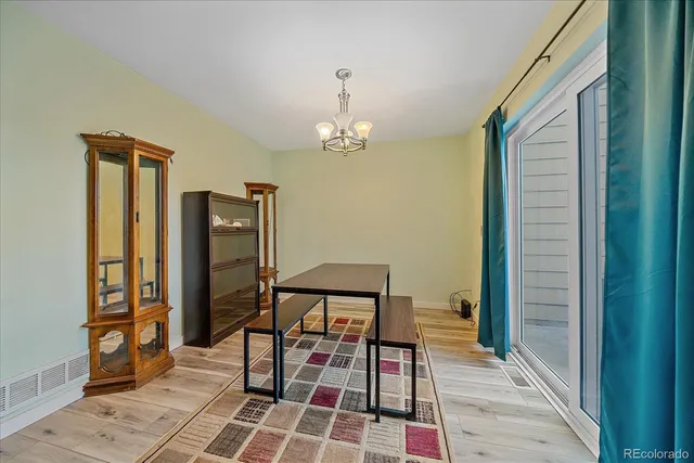 a dining room with furniture and a chandelier