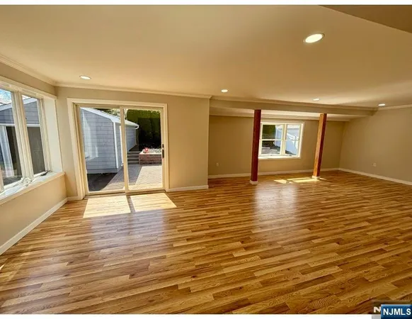 a view of a room with wooden floor and window
