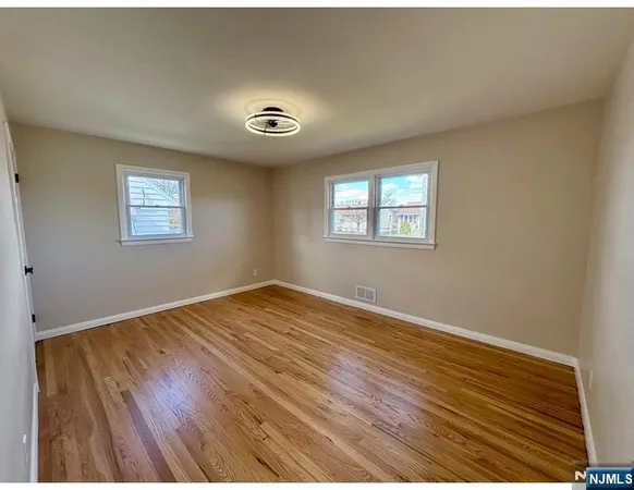 a view of a room with wooden floor and a window
