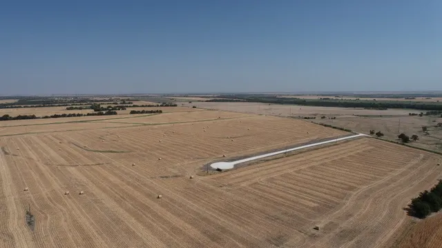 a view of a room with an empty space and wooden floor