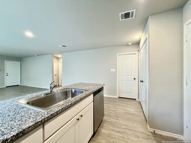 a kitchen with a sink and cabinets