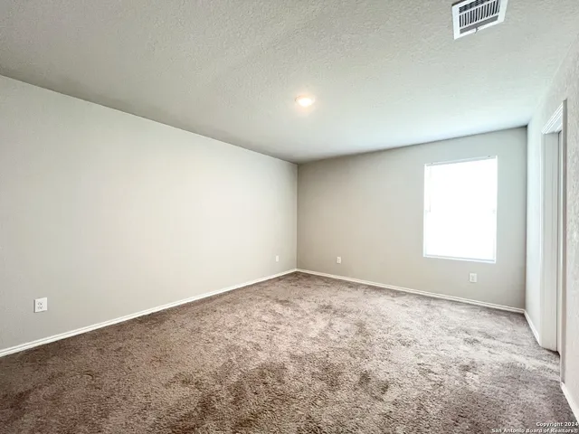 an empty room with a empty space and a window