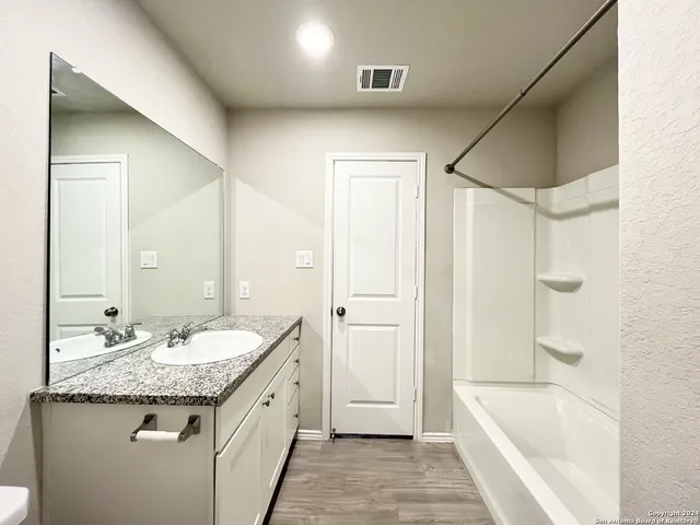 a bathroom with a bathtub and shower