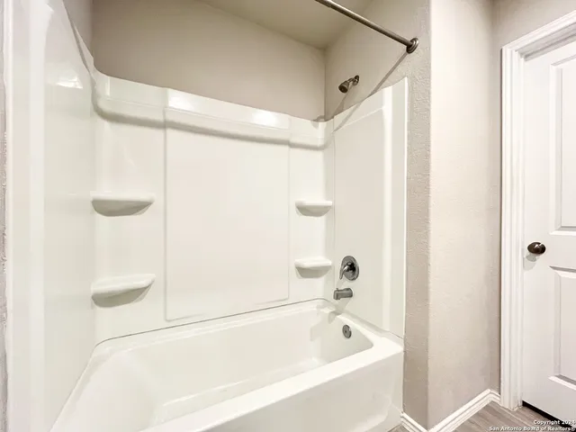 a bathroom with a granite countertop sink a toilet and a mirror