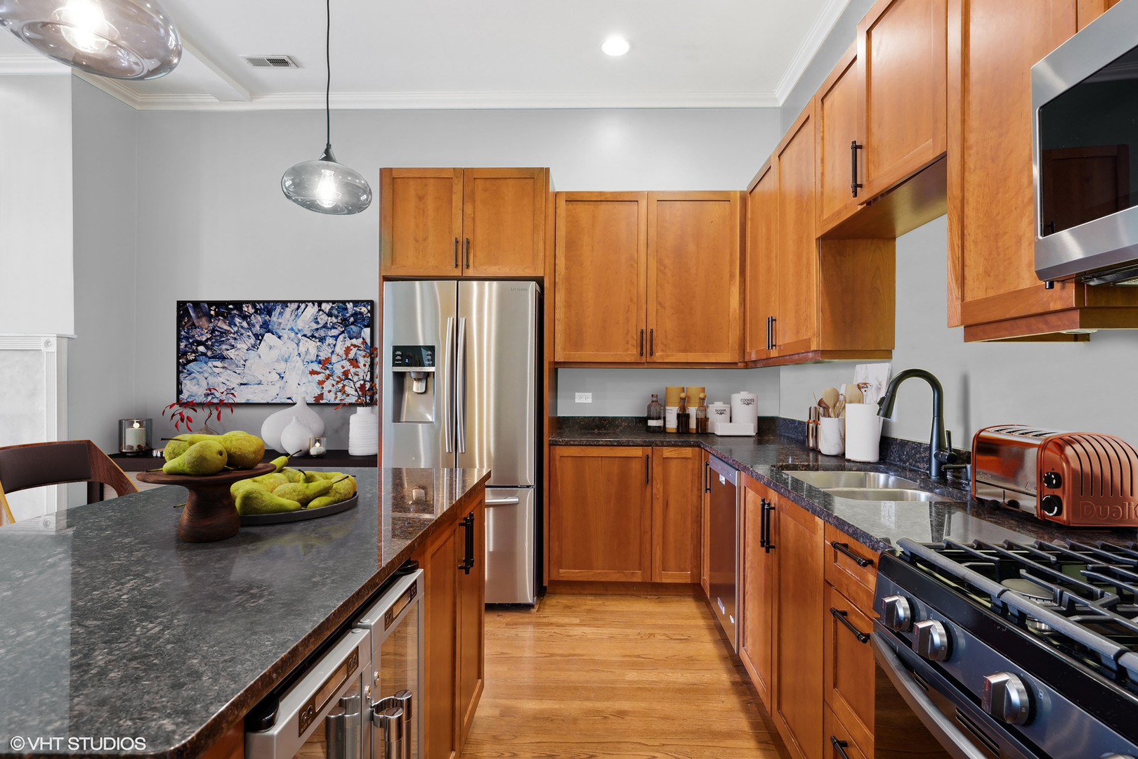 1555 North Wood Street, Unit 302 Chicago, IL 60622 - Photo 4 of 14 a kitchen with stainless steel appliances granite countertop a refrigerator a sink and wooden cabinets