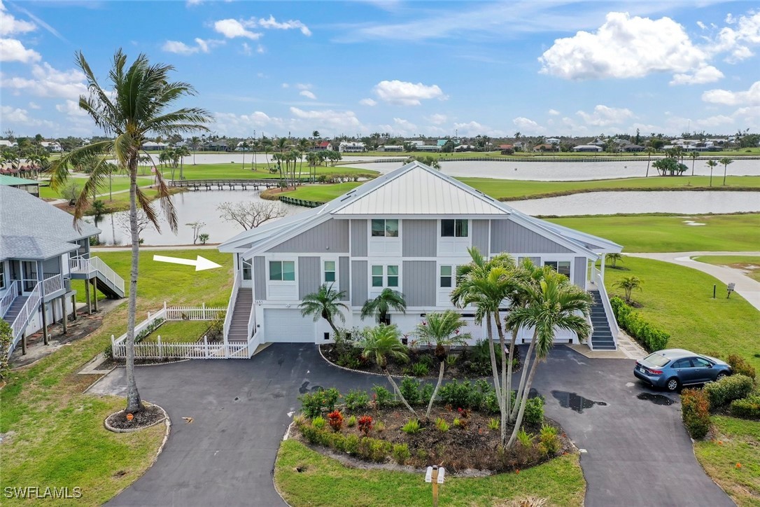 a aerial view of a house with a garden and swimming pool