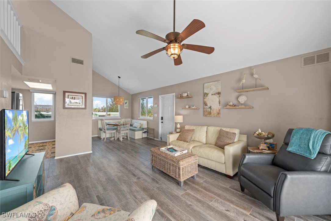 1651 Sand Castle Road Sanibel, FL 33957 - Photo 11 of 50 a living room with furniture and a wooden floor