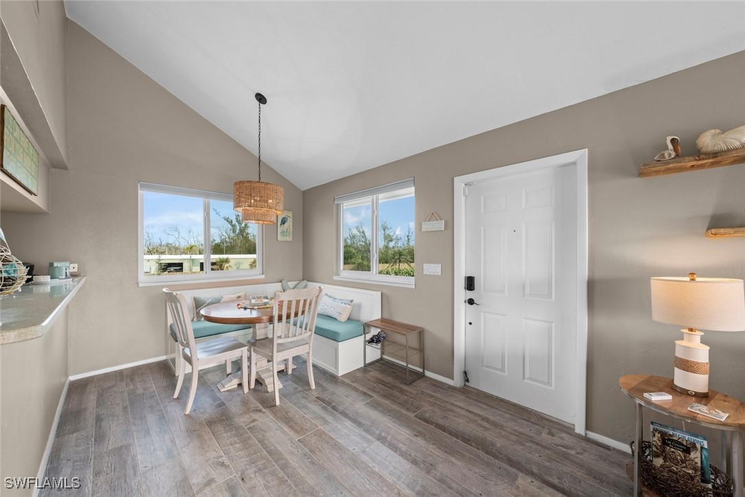 1651 Sand Castle Road Sanibel, FL 33957 - Photo 14 of 50 a dining room with furniture a chandelier and wooden floor
