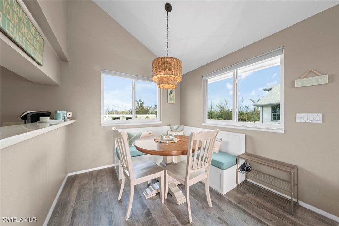 1651 Sand Castle Road Sanibel, FL 33957 - Photo 15 of 50 a dining room with furniture a chandelier and wooden floor