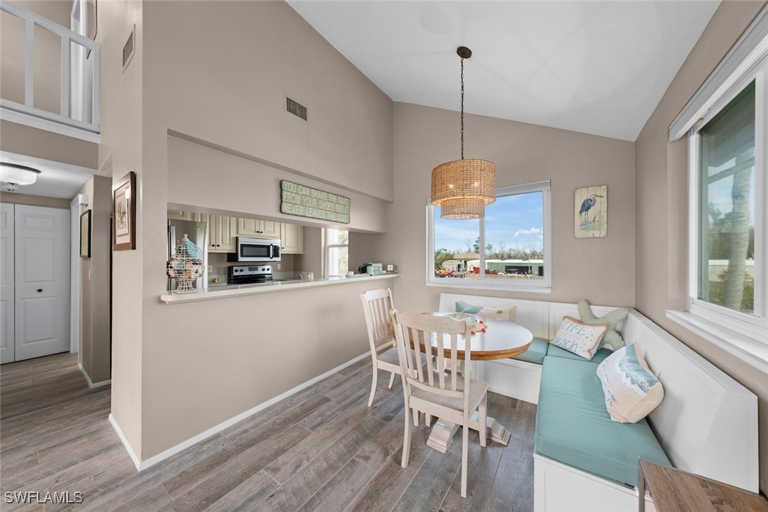 1651 Sand Castle Road Sanibel, FL 33957 - Photo 17 of 50 a view of a dining room with furniture window and wooden floor