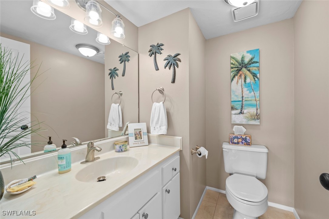 1651 Sand Castle Road Sanibel, FL 33957 - Photo 24 of 50 a bathroom with a sink a toilet and a mirror