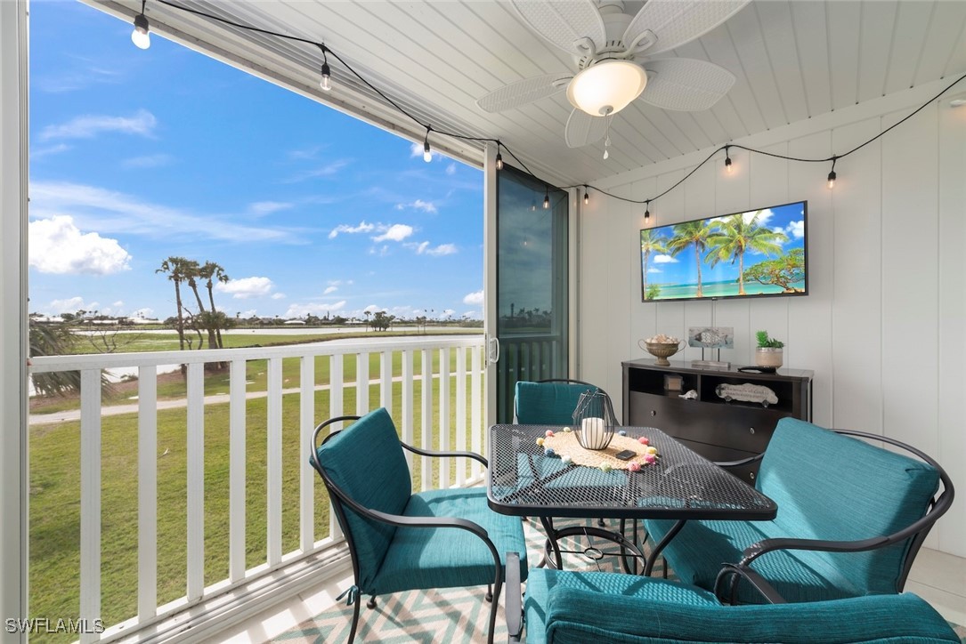 1651 Sand Castle Road Sanibel, FL 33957 - Photo 27 of 50 a view of a dining room with furniture wooden floor and chandelier