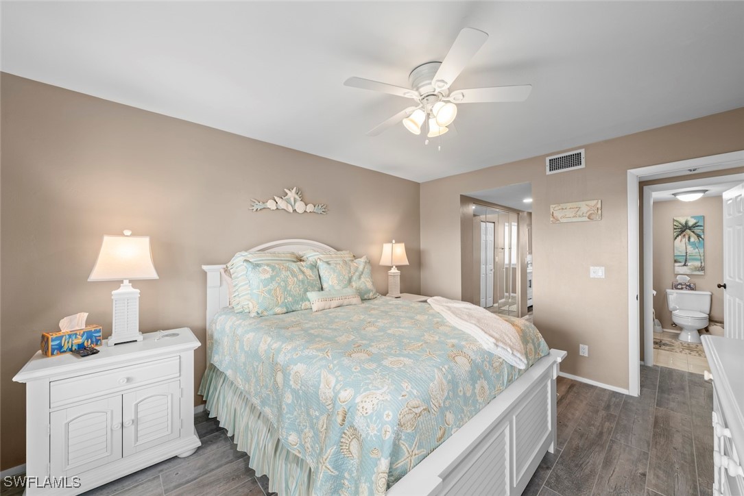 1651 Sand Castle Road Sanibel, FL 33957 - Photo 28 of 50 a bedroom with a bed and a chandelier