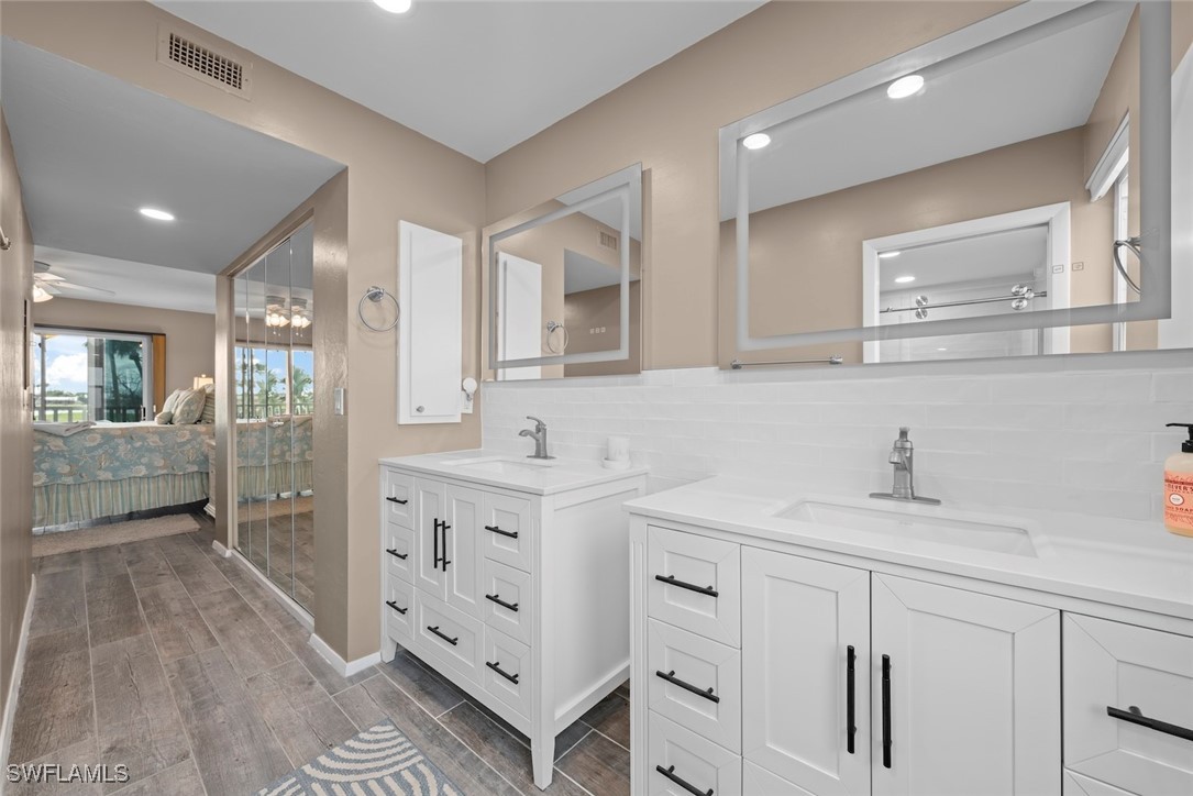 1651 Sand Castle Road Sanibel, FL 33957 - Photo 29 of 50 a bathroom with a sink a mirror and a shower