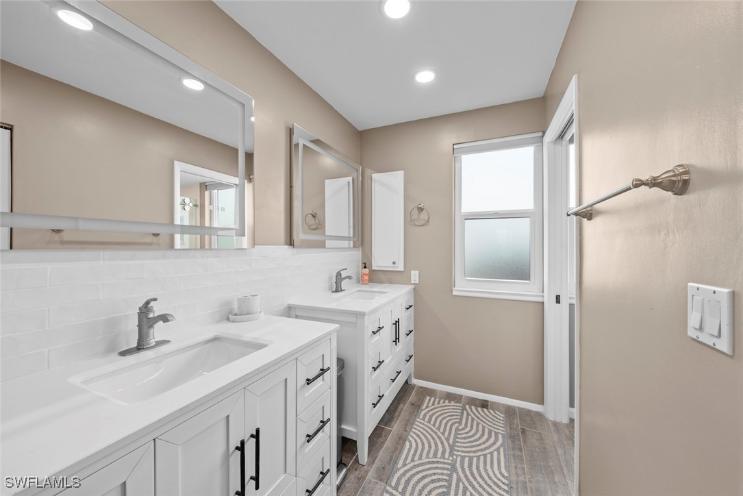 1651 Sand Castle Road Sanibel, FL 33957 - Photo 31 of 50 a bathroom with a sink and a mirror