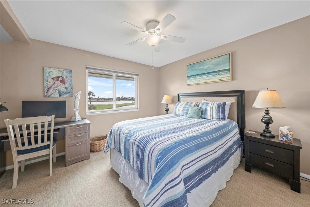 1651 Sand Castle Road Sanibel, FL 33957 - Photo 33 of 50 a bedroom with a bed and a chandelier