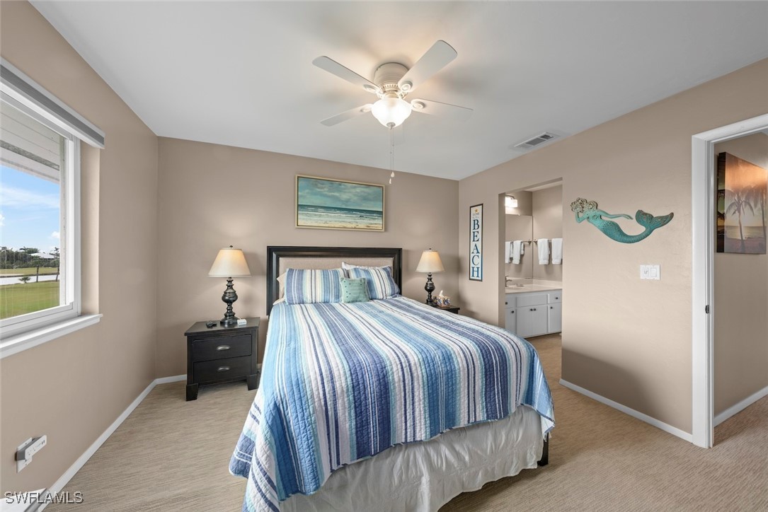 1651 Sand Castle Road Sanibel, FL 33957 - Photo 35 of 50 a bedroom with a large bed and a chandelier
