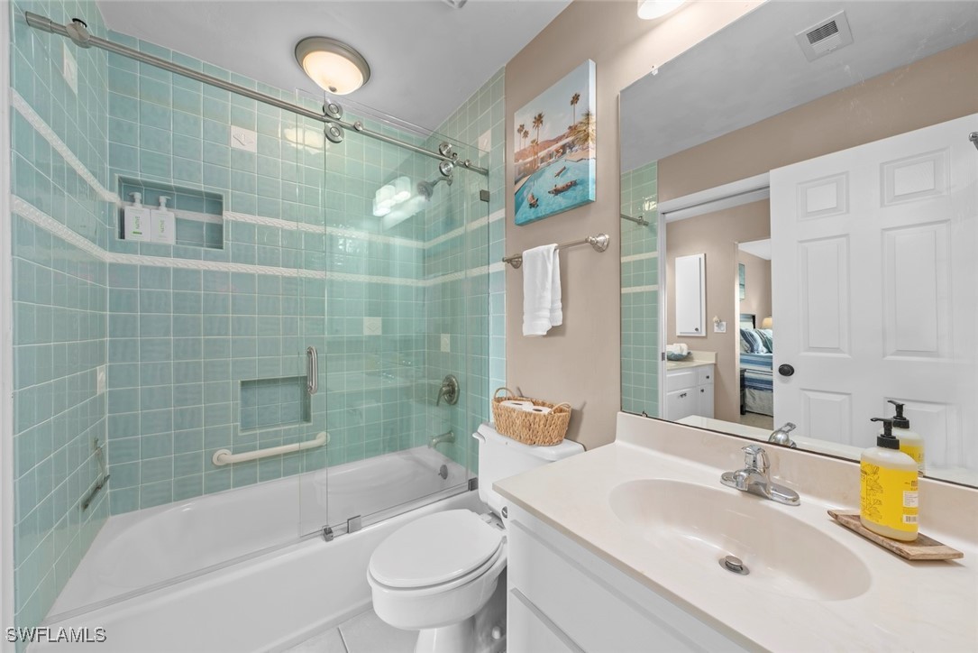 1651 Sand Castle Road Sanibel, FL 33957 - Photo 38 of 50 a bathroom with a sink mirror toilet and bathtub