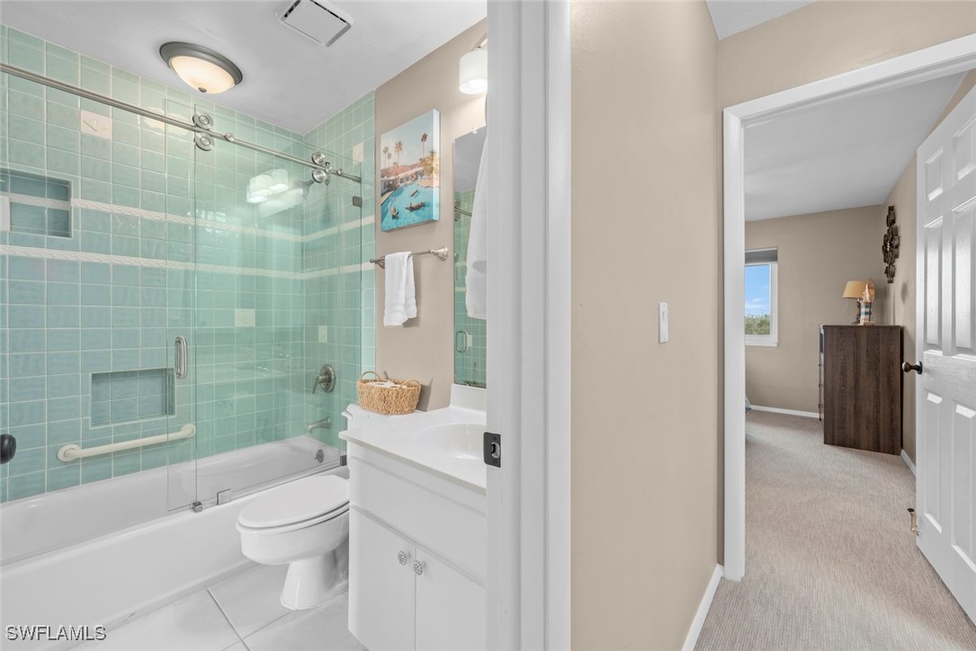 1651 Sand Castle Road Sanibel, FL 33957 - Photo 39 of 50 a bathroom with a sink a toilet a mirror and shower