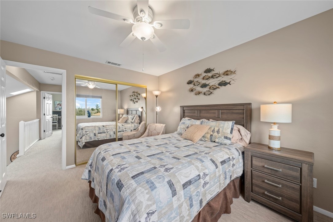 1651 Sand Castle Road Sanibel, FL 33957 - Photo 41 of 50 a bedroom with a large bed and a chandelier
