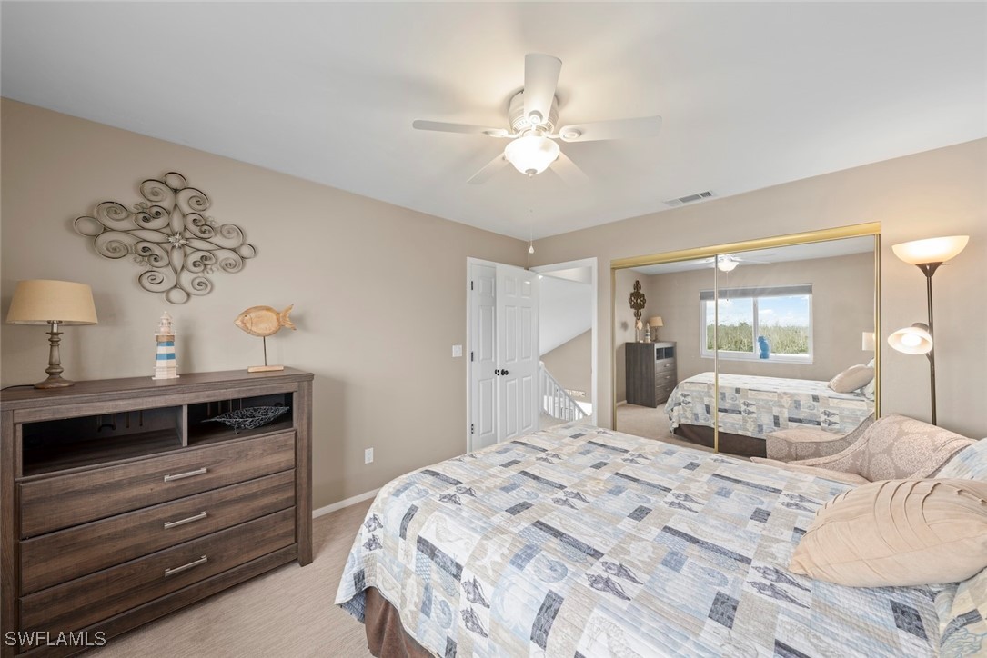 1651 Sand Castle Road Sanibel, FL 33957 - Photo 42 of 50 a bedroom with a bed and a chandelier