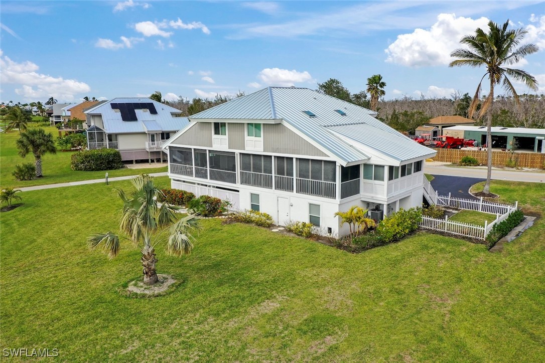 1651 Sand Castle Road Sanibel, FL 33957 - Photo 45 of 50 a view of a house with pool and chairs