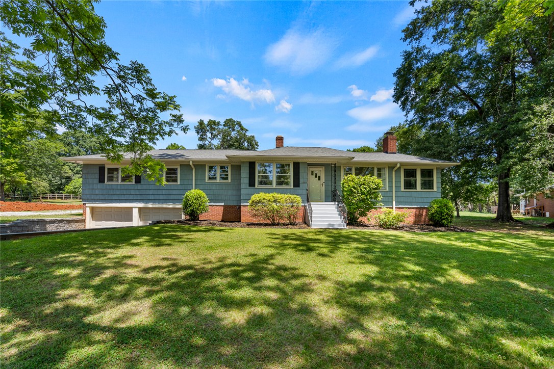 1509 869 Anderson, SC 29621 - Photo 1 of 45 A classic ranch home nestled among established trees, featuring an inviting lawn and accessible garage.