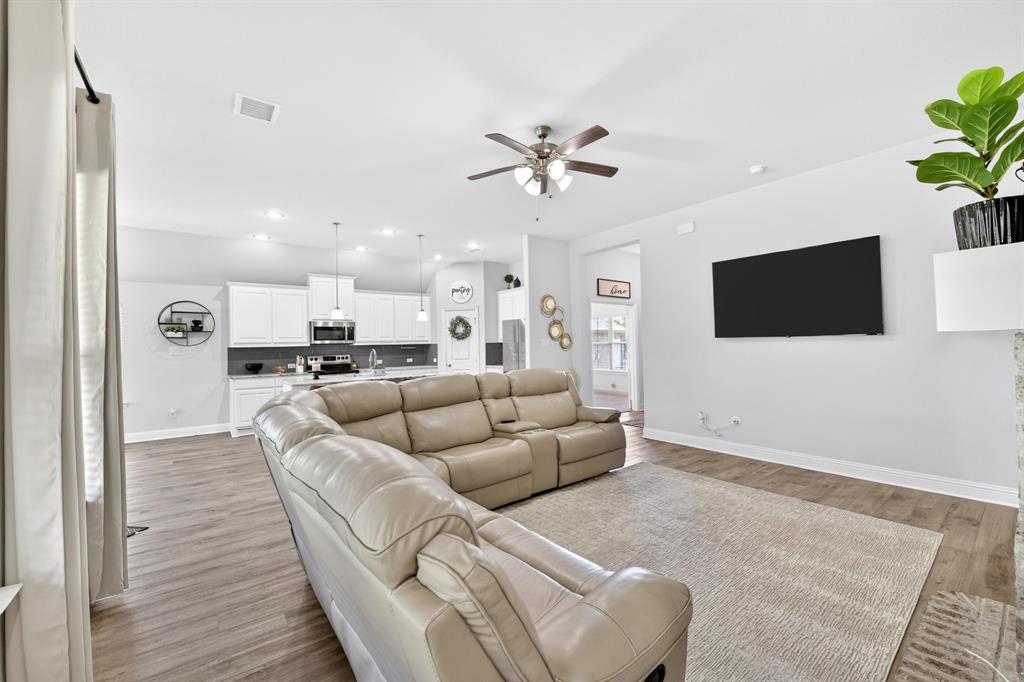 136 Gleeson Drive Red Oak, TX 75154 - Photo 19 of 40 a living room with furniture and a flat screen tv