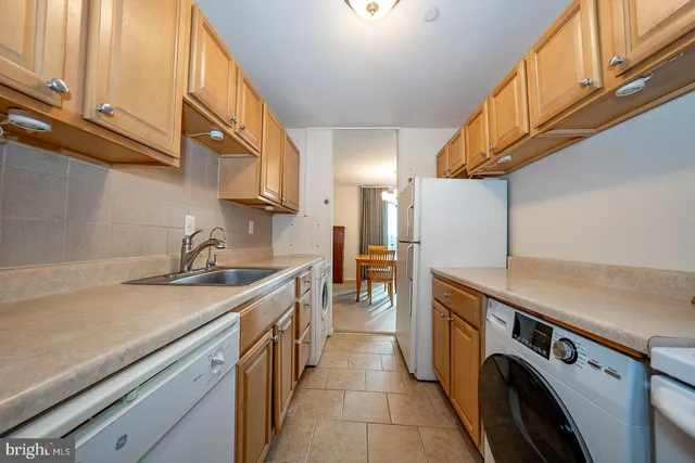 a utility room with sink dryer and washer