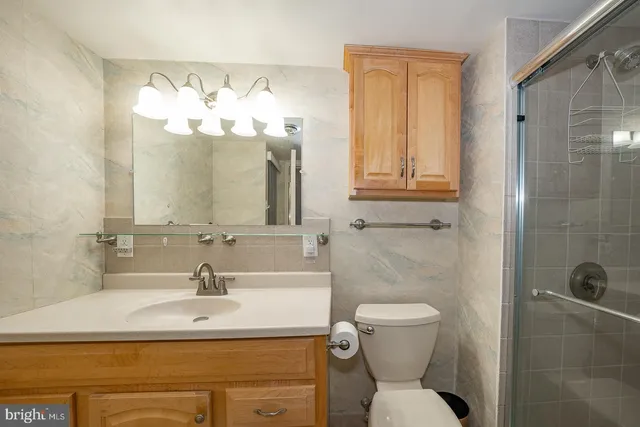 a bathroom with a sink toilet and mirror