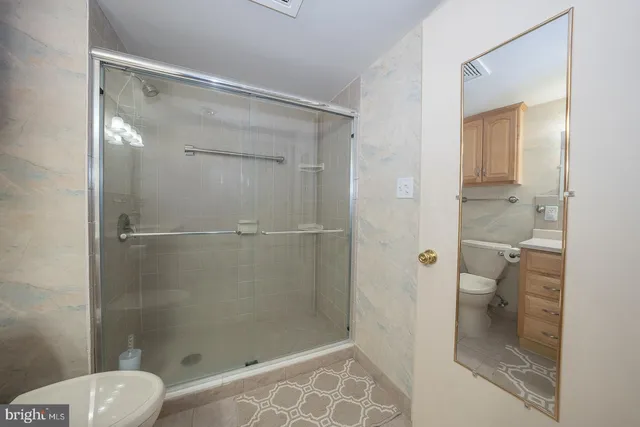 a bathroom with a glass shower door