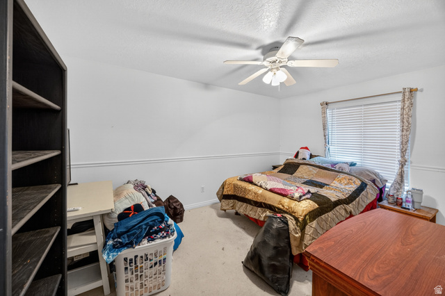 1218 East 100 South Logan, UT 84321 - Photo 15 of 23 Carpeted room featuring a ceiling fan, window with blinds, and white baseboards and chair rail molding