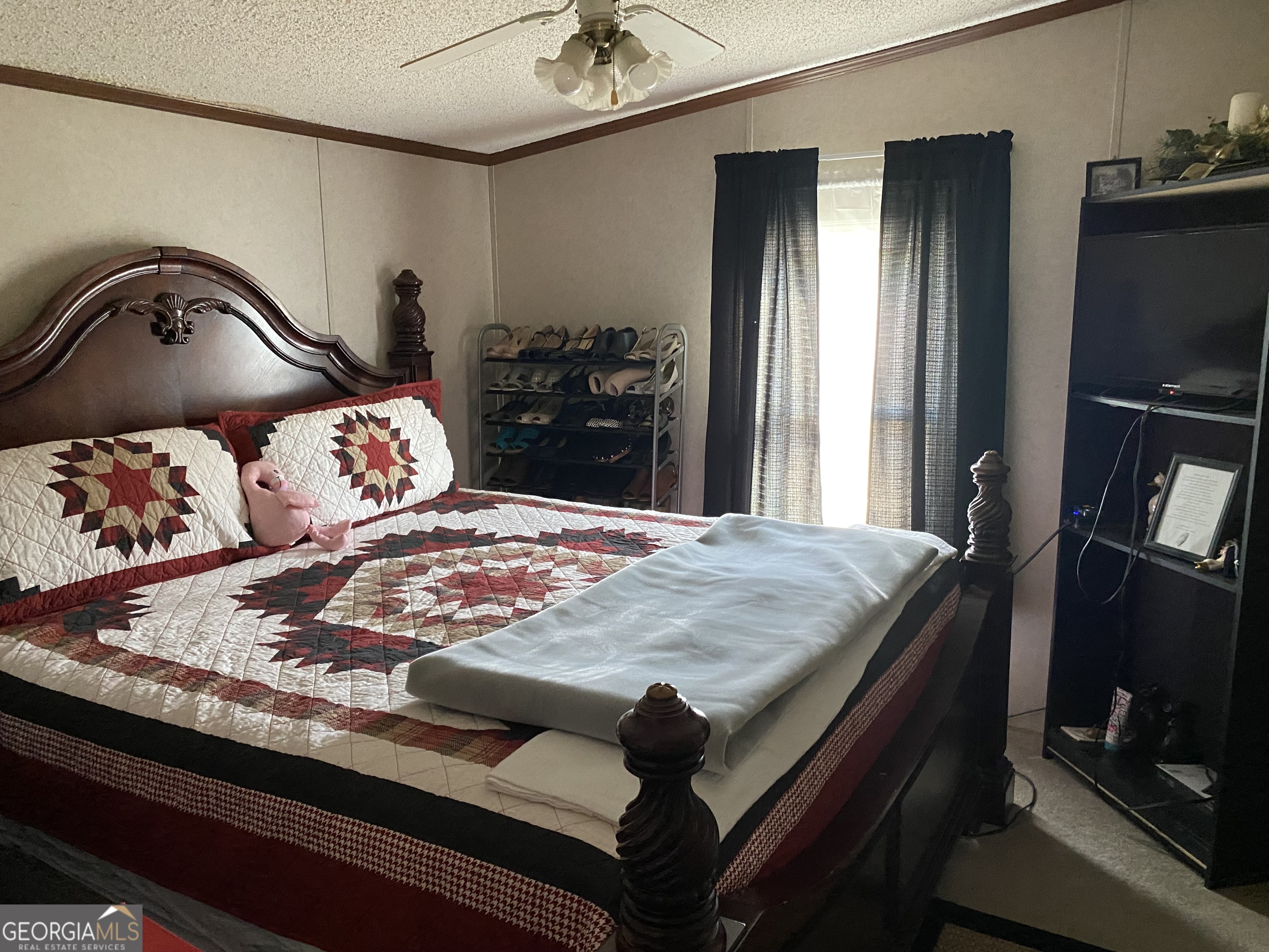 580 Centralia Rachels Road Warthen, GA 31094 - Photo 25 of 40 a bedroom with a bed and a flat tv screen on dresser