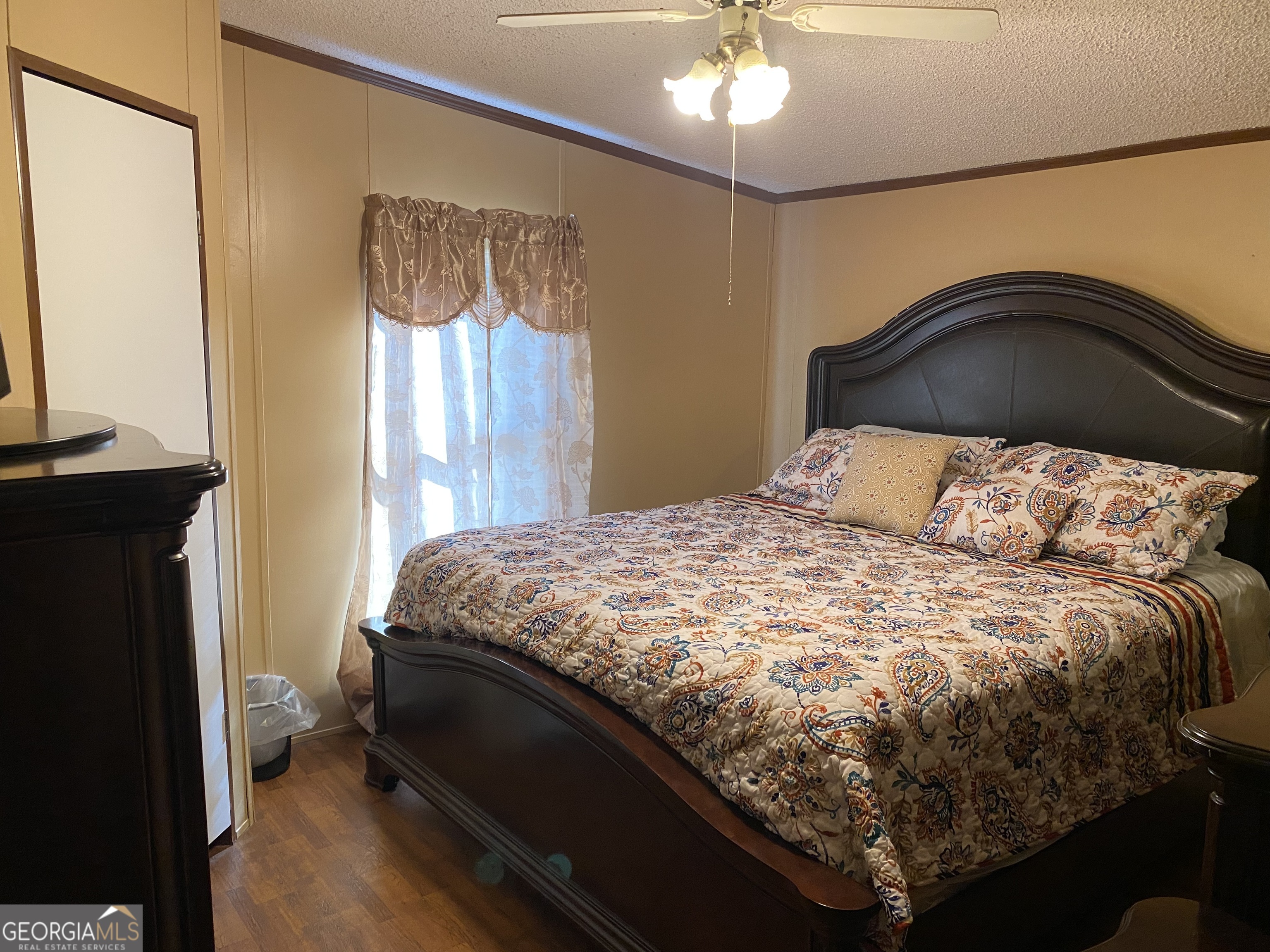 580 Centralia Rachels Road Warthen, GA 31094 - Photo 28 of 40 a bedroom with a bed and a chandelier