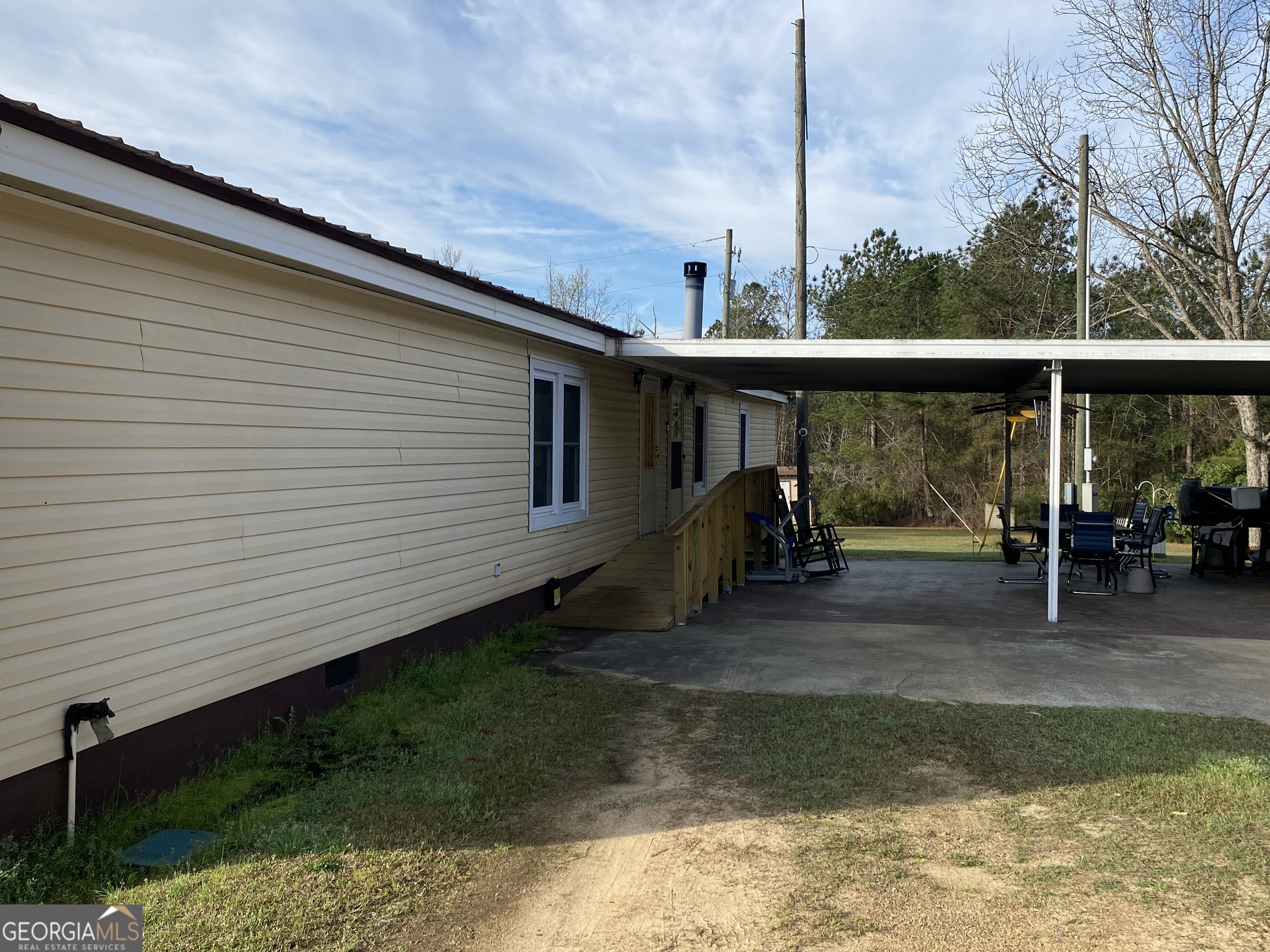 580 Centralia Rachels Road Warthen, GA 31094 - Photo 3 of 40 a view of a backyard with floor to ceiling window and wooden fence