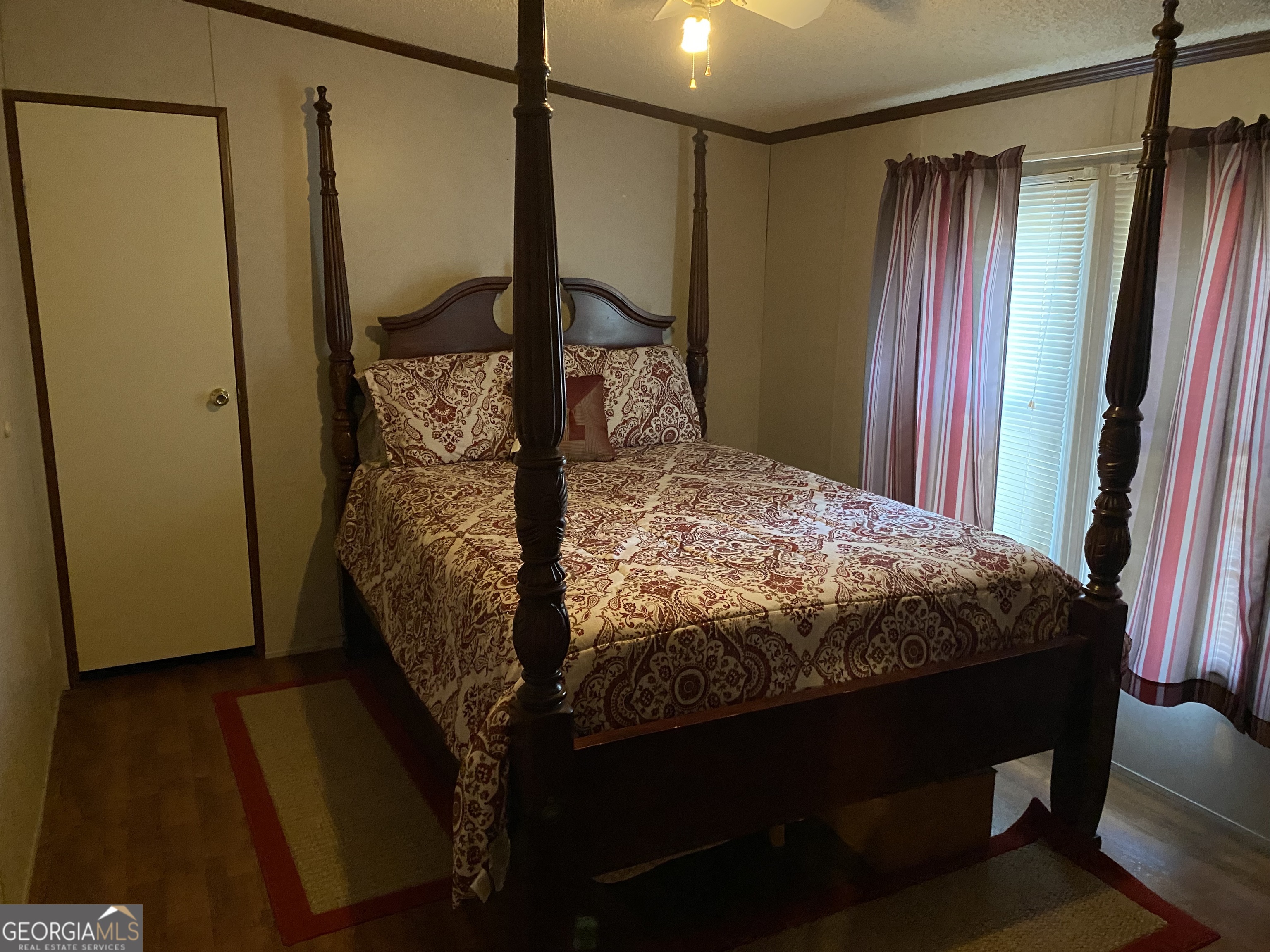 580 Centralia Rachels Road Warthen, GA 31094 - Photo 31 of 40 a bed sitting in a bedroom next to a window